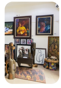African Artifacts displayed in room with walls decorated with painting in Asaba